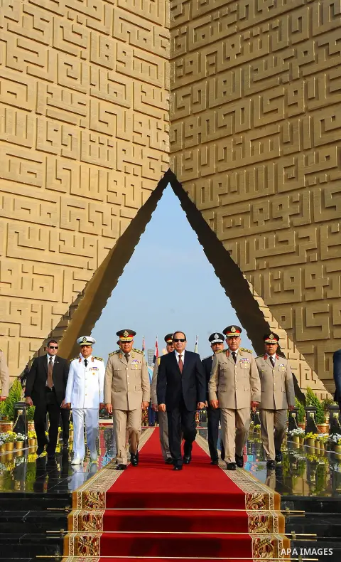 A handout picture released by the Egyptian Presidency shows Egyptian President Abdul Fattah al-Sisi (C), Defense Minister Sedki Sobhi (L) and Chief of Staff Mahmoud Hegazy (R) leaving after their visit to former Egyptian...