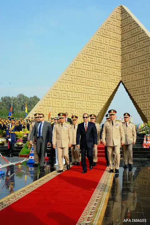 A handout picture released by the Egyptian Presidency shows Egyptian President Abdul Fattah al-Sisi (C), Defense Minister Sedki Sobhi (L) and Chief of Staff Mahmoud Hegazy (R) leaving after their visit to former Egyptian...