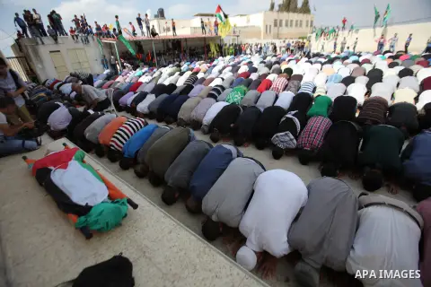 Palestinian mourners pray over the body of Huzaifah Sulaiman during his funeral in Balaa village near the West Bank city of Tulkarem, October 5, 2015. Tensions have been further inflamed by frequent clashes between Pales...