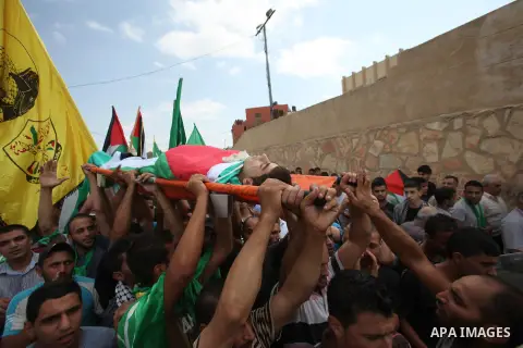 Palestinian mourners carry the body of Huzaifah Sulaiman during his funeral in Balaa village near the West Bank city of Tulkarem, October 5, 2015. Tensions have been further inflamed by frequent clashes between Palestini...