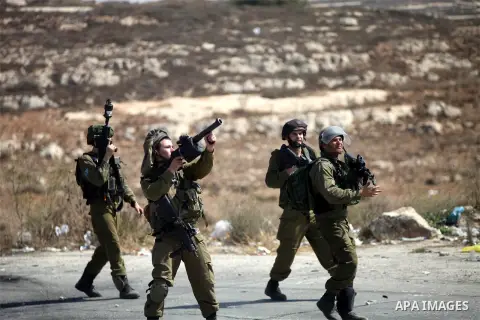 An Israeli soldier fires tear gas towards Palestinian protesters during clashes near the Jewish settlement of Bet El, near the occupied West Bank city of Ramallah October 5, 2015. Violence intensified in Jerusalem and th...
