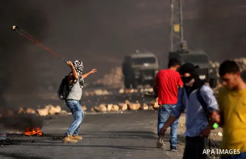 Palestinian protesters throw stones towards Israeli troops during clashes near the Jewish settlement of Bet El, near the occupied West Bank city of Ramallah October 5, 2015. Violence intensified in Jerusalem and the West...