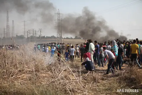Palestinian protesters gather during clashes with Israeli security forces near the border fence between Israel and the Gaza Strip on October 9, 2015 east of Gaza City. A week of violence between Israelis and Palestinians...