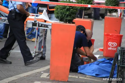 Israeli police secure the area as they stand next to the body of a dead Palestinian assailant at the spot where he stabbed two Israeli Jews before was shot dead outside Jerusalem's Old City October 10, 2015. Israeli forc...