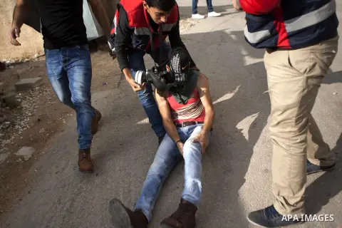 A Palestinian protester is evacuated by comrades after being injured during clashes with Israeli security forces in Beit El on the outskirts of the West Bank city of Ramallah, on October 10, 2015. Fifteen Palestinians ha...