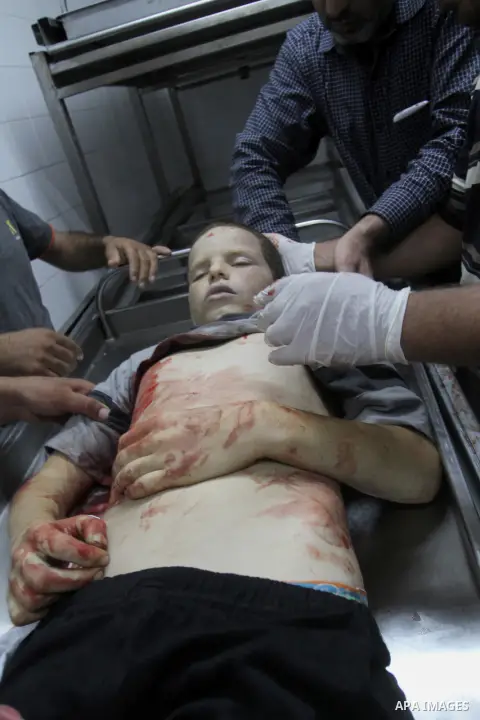 Relatives look at the body of Palestinian boy Marwan Barbakh, 12, who was shot dead by Israeli forces on Saturday, at a hospital morgue in Khan Younis in the southern Gaza Strip October 10, 2015. Israeli security forces...