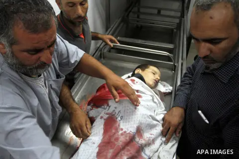 Palestinians gather around the body of Palestinian boy Marwan Barbakh,12, who was shot dead by Israeli forces on Saturday, at a hospital morgue in Khan Younis in the southern Gaza Strip October 10, 2015. Israeli security...