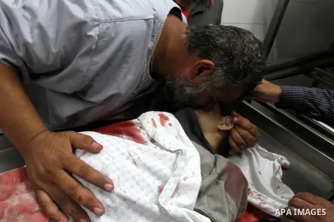 Palestinians gather around the body of Palestinian boy Marwan Barbakh,12, who was shot dead by Israeli forces on Saturday, at a hospital morgue in Khan Younis in the southern Gaza Strip October 10, 2015. Israeli security...
