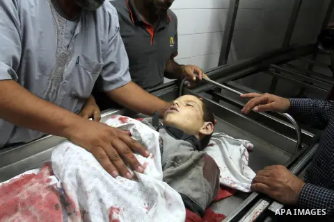 Palestinians gather around the body of Palestinian boy Marwan Barbakh,12, who was shot dead by Israeli forces on Saturday, at a hospital morgue in Khan Younis in the southern Gaza Strip October 10, 2015. Israeli security...
