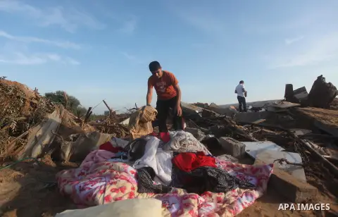 Palestinians inspect the damage after an Israeli retaliatory air strike demolished the house of a Palestinian family on October 11, 2015 in the Zeitun sector south of Gaza City. A pregnant Palestinian mother and her todd...