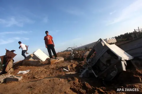 Palestinians inspect the damage after an Israeli retaliatory air strike demolished the house of a Palestinian family on October 11, 2015 in the Zeitun sector south of Gaza City. A pregnant Palestinian mother and her todd...