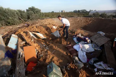Palestinians inspect the damage after an Israeli retaliatory air strike demolished the house of a Palestinian family on October 11, 2015 in the Zeitun sector south of Gaza City. A pregnant Palestinian mother and her todd...