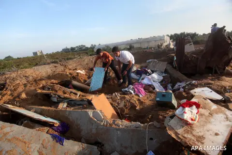 Palestinians inspect the damage after an Israeli retaliatory air strike demolished the house of a Palestinian family on October 11, 2015 in the Zeitun sector south of Gaza City. A pregnant Palestinian mother and her todd...