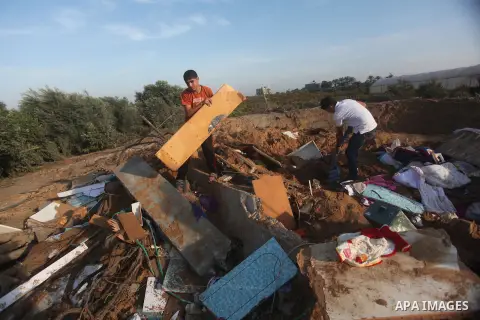 Palestinians inspect the damage after an Israeli retaliatory air strike demolished the house of a Palestinian family on October 11, 2015 in the Zeitun sector south of Gaza City. A pregnant Palestinian mother and her todd...