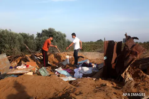 Palestinians inspect the damage after an Israeli retaliatory air strike demolished the house of a Palestinian family on October 11, 2015 in the Zeitun sector south of Gaza City. A pregnant Palestinian mother and her todd...