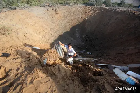 Palestinians inspect the damage after an Israeli retaliatory air strike demolished the house of a Palestinian family on October 11, 2015 in the Zeitun sector south of Gaza City. A pregnant Palestinian mother and her todd...