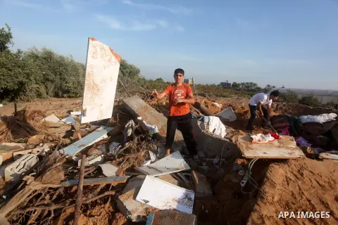 Palestinians inspect the damage after an Israeli retaliatory air strike demolished the house of a Palestinian family on October 11, 2015 in the Zeitun sector south of Gaza City. A pregnant Palestinian mother and her todd...