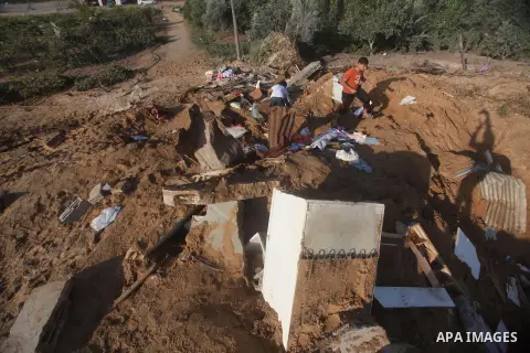 Palestinians inspect the damage after an Israeli retaliatory air strike demolished the house of a Palestinian family on October 11, 2015 in the Zeitun sector south of Gaza City. A pregnant Palestinian mother and her todd...