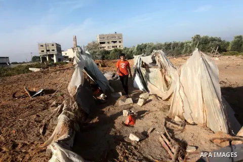 Palestinians inspect the damage after an Israeli retaliatory air strike demolished the house of a Palestinian family on October 11, 2015 in the Zeitun sector south of Gaza City. A pregnant Palestinian mother and her todd...