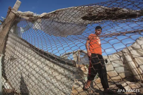 Palestinians inspect the damage after an Israeli retaliatory air strike demolished the house of a Palestinian family on October 11, 2015 in the Zeitun sector south of Gaza City. A pregnant Palestinian mother and her todd...