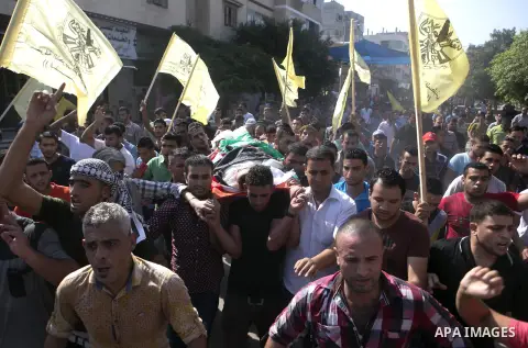 Mourners carry the body of Palestinian boy Marwan Barbakh, 12, who was shot dead by Israeli forces on Saturday, during his funeral in Khan Younis in the southern Gaza Strip October 11, 2015. Israeli security forces on Sa...