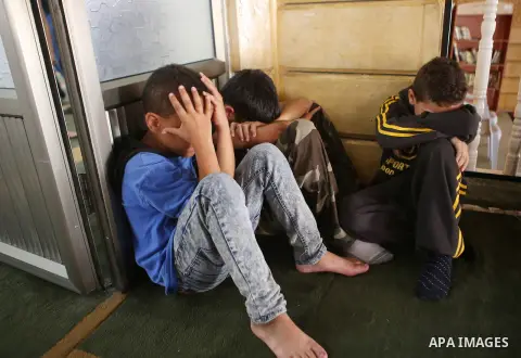 Relatives of 13-year-old Palestinian boy Ahmed Sharaka, who was killed by Israeli troops during clashes on Sunday after being hit in the head by a plastic-coated metal bullet, mourn during his funeral in Jalazoun refugee...