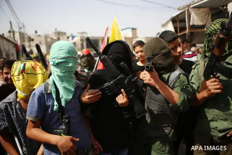 Relatives of 13-year-old Palestinian boy Ahmed Sharaka, who was killed by Israeli troops during clashes on Sunday after being hit in the head by a plastic-coated metal bullet, mourn during his funeral in Jalazoun refugee...