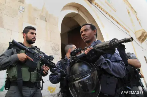 Israeli policemen secure the visit of Israeli MP and chairperson of the center Atid party, Yair Lapid, at the Lion Gate in Jerusalem's Old City on October 12, 2015, as he visits Israeli security forces at the location fo...