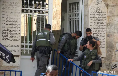 Israeli policemen secure the visit of Israeli MP and chairperson of the center Atid party, Yair Lapid, at the Lion Gate in Jerusalem's Old City on October 12, 2015, as he visits Israeli security forces at the location fo...