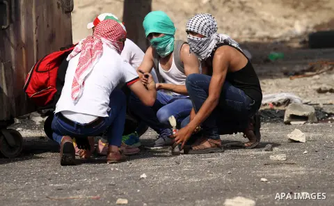 Palestinian protesters clash with Israeli security forces at the Hawara checkpoint, south of the West Bank city of Nablus, on October 12, 2015. Three new stabbings in Jerusalem and a car attack spread more fear among Isr...