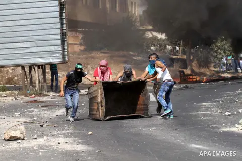 Palestinian protesters clash with Israeli security forces at the Hawara checkpoint, south of the West Bank city of Nablus, on October 12, 2015. Three new stabbings in Jerusalem and a car attack spread more fear among Isr...