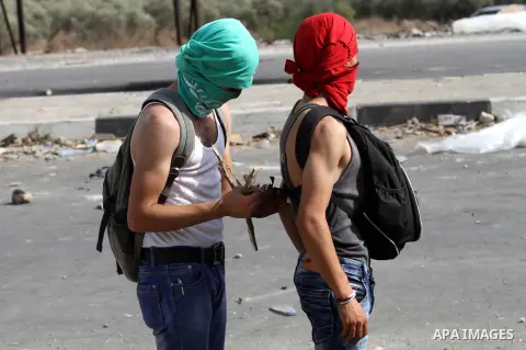Palestinian protesters clash with Israeli security forces at the Hawara checkpoint, south of the West Bank city of Nablus, on October 12, 2015. Three new stabbings in Jerusalem and a car attack spread more fear among Isr...
