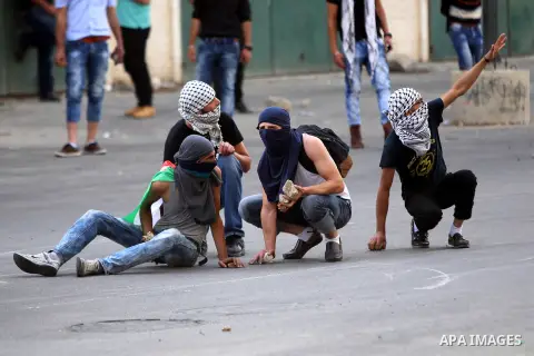 Palestinian protesters clash with Israeli security forces in Beit El on the outskirts of the West Bank city of Ramallah, on October 12, 2015. Three new stabbings in Jerusalem and a car attack spread more fear among Israe...