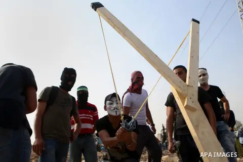 Palestinian protesters clash with Israeli security forces in Beit El on the outskirts of the West Bank city of Ramallah, on October 12, 2015. Three new stabbings in Jerusalem and a car attack spread more fear among Israe...