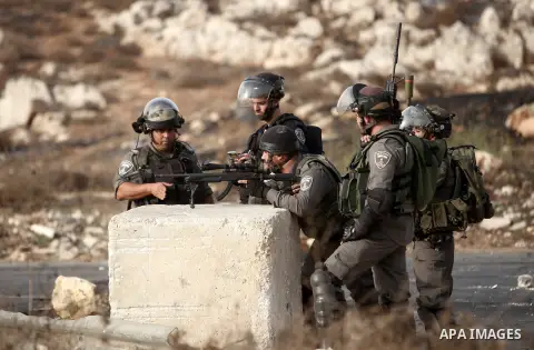 Israeli border guards keep position during clashes with Palestinian protesters in Beit El on the outskirts of the West Bank city of Ramallah, on October 12, 2015. Three new stabbings in Jerusalem and a car attack spread...