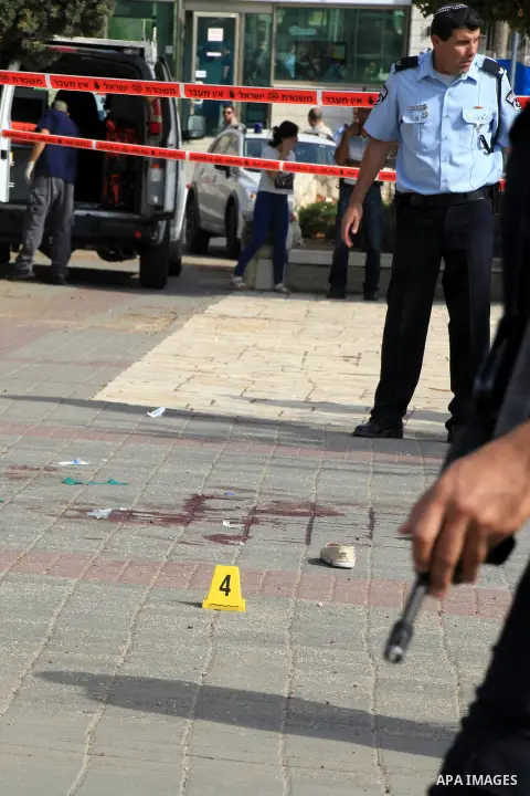 Israeli police officers survey the scene of a stabbing in Jerusalem October 12, 2015. Palestinians escalated the pace of stabbing attacks in the Jerusalem area on Monday and Israeli police shot dead two of the alleged as...