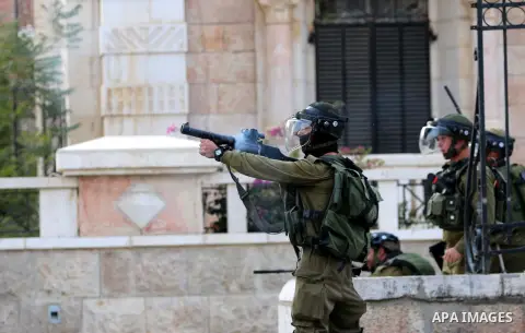 Israeli soldiers aim their weapons towards Palestinian protesters during clashes at the main entrance of the West Bank city of Bethlehem, on October 12, 2015. Frustrated Palestinian youths have defied president Mahmud Ab...