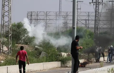 Palestinians gather during clashes with Israeli security forces near the Erez border crossing between Israel and northern Gaza Strip on October 13, 2015. A wave of stabbings that hit Israel, Jerusalem and the West Bank t...