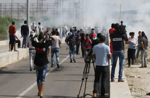Palestinians gather during clashes with Israeli security forces near the Erez border crossing between Israel and northern Gaza Strip on October 13, 2015. A wave of stabbings that hit Israel, Jerusalem and the West Bank t...