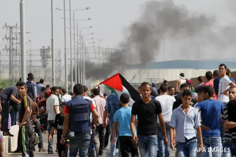 Palestinians gather during clashes with Israeli security forces near the Erez border crossing between Israel and northern Gaza Strip on October 13, 2015. A wave of stabbings that hit Israel, Jerusalem and the West Bank t...