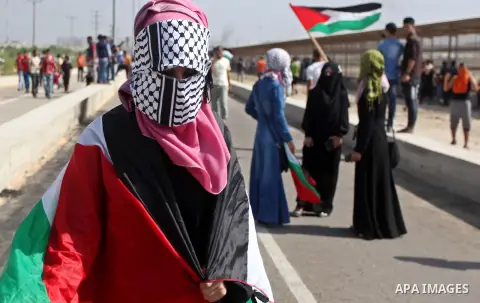 Palestinian girls gather during clashes with Israeli security forces next to the border fence with Israel, at the Erez crossing in the northern Gaza strip, on October 13, 2015. A wave of stabbings that hit Israel, Jerusa...