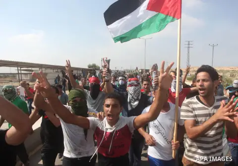 Palestinian protesters shot slogans during clashes with Israeli security forces next to the border fence with Israel, at the Erez crossing in the northern Gaza strip, on October 13, 2015. A wave of stabbings that hit Isr...