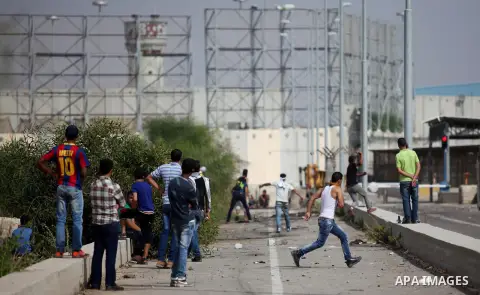 Palestinian protesters clash with Israeli security forces next to the border fence with Israel, at the Erez crossing in the northern Gaza strip, on October 13, 2015. A wave of stabbings that hit Israel, Jerusalem and the...