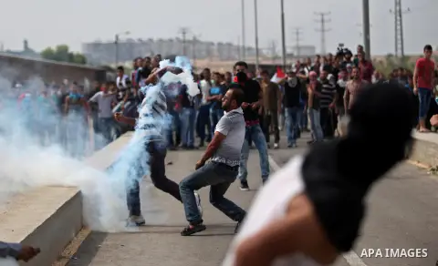 Palestinian protesters clash with Israeli security forces next to the border fence with Israel, at the Erez crossing in the northern Gaza strip, on October 13, 2015. A wave of stabbings that hit Israel, Jerusalem and the...