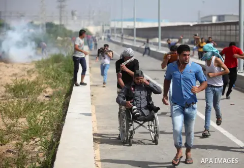 Palestinian protesters clash with Israeli security forces next to the border fence with Israel, at the Erez crossing in the northern Gaza strip, on October 13, 2015. A wave of stabbings that hit Israel, Jerusalem and the...