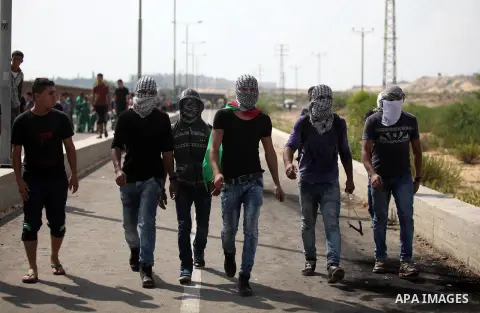 Palestinian protesters clash with Israeli security forces next to the border fence with Israel, at the Erez crossing in the northern Gaza strip, on October 13, 2015. A wave of stabbings that hit Israel, Jerusalem and the...