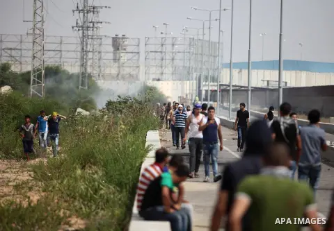 Palestinian protesters clash with Israeli security forces next to the border fence with Israel, at the Erez crossing in the northern Gaza strip, on October 13, 2015. A wave of stabbings that hit Israel, Jerusalem and the...