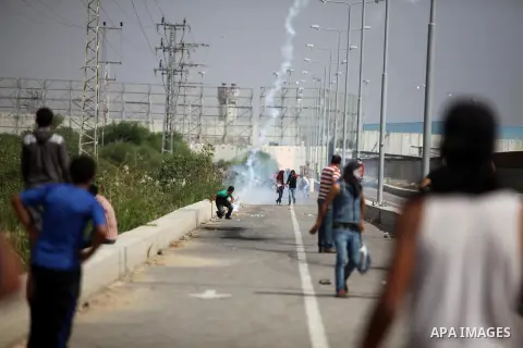 Palestinian protesters clash with Israeli security forces next to the border fence with Israel, at the Erez crossing in the northern Gaza strip, on October 13, 2015. A wave of stabbings that hit Israel, Jerusalem and the...