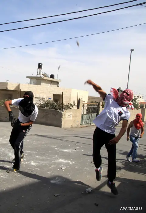 Palestinian protesters throw stones at Israeli police during clashes in Jabal al-Mukaber neighborhood, southern Jerusalem, on October 13, 2015. A wave of stabbings that hit Israel, Jerusalem and the West Bank this month...