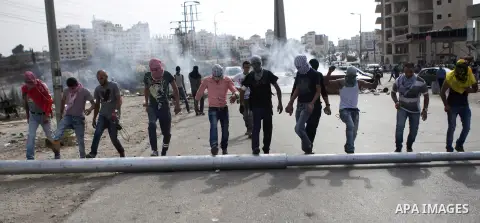 Palestinian protesters set barricades during clashes with Israeli security forces near the Jewish settlement of Bet El, near the West Bank city of Ramallah, on October 13, 2015. A wave of stabbings that hit Israel, Jerus...